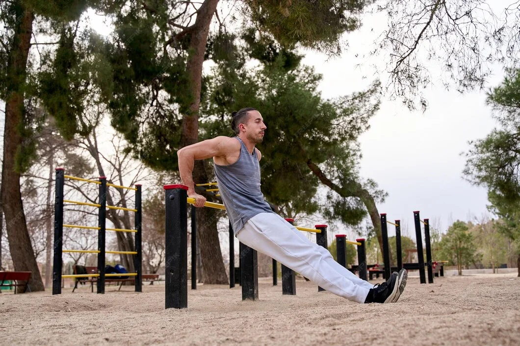 A man performs push-ups on a park bench, demonstrating fitness in an outdoor setting.